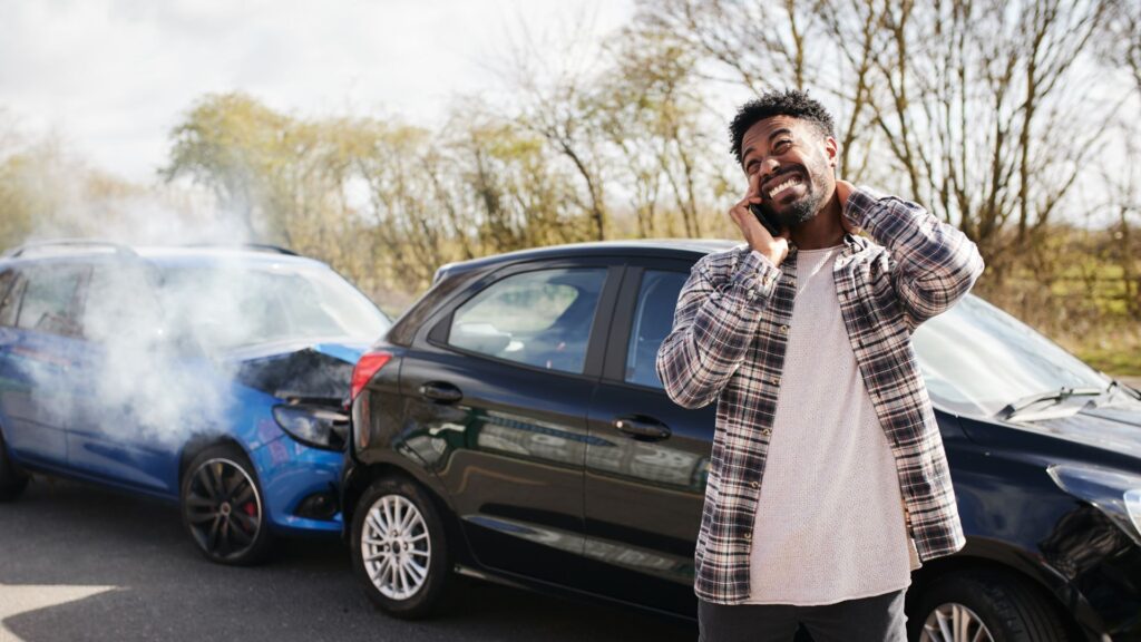 A man on the phone after getting in a car accident.