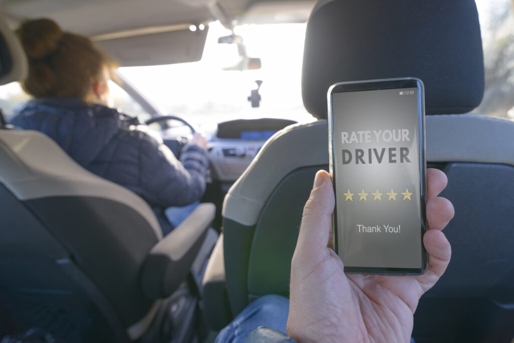 A rideshare passenger rating their driver on their phone.