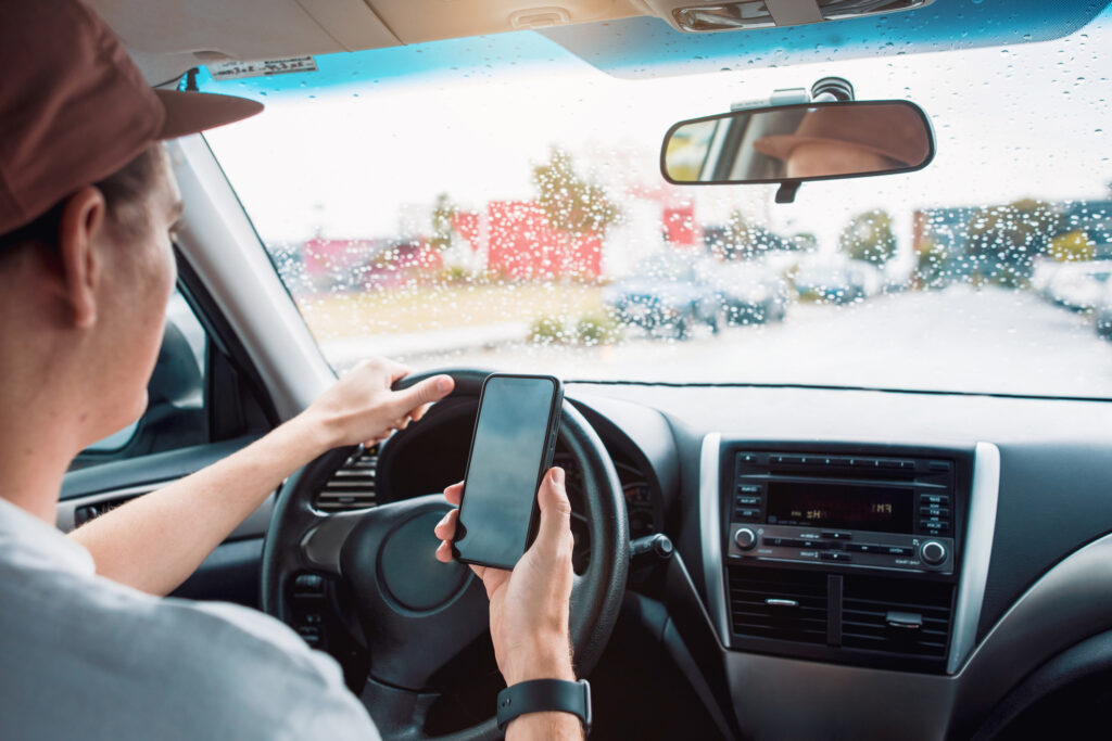 An Uber driver on the phone while driving.