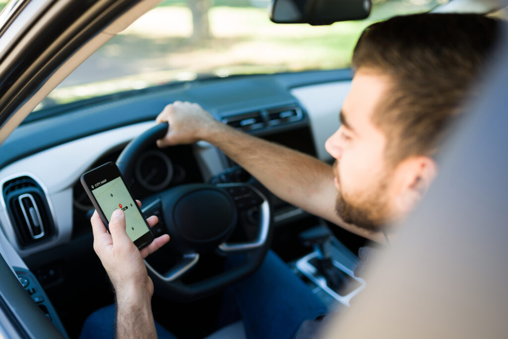 A man on his phone while driving.