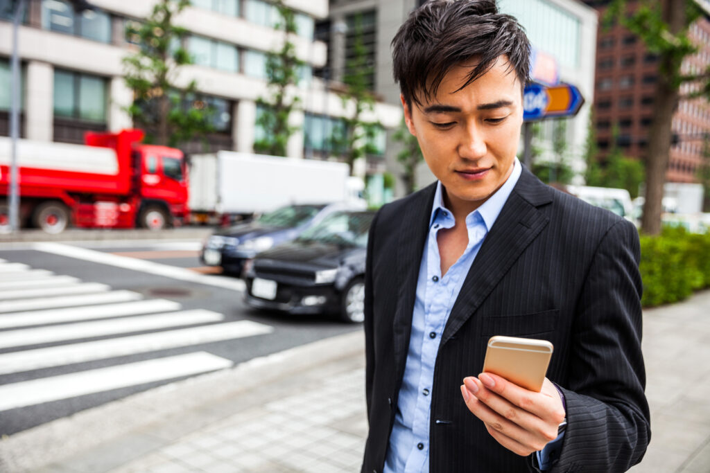 A concerned man looking at his phone.