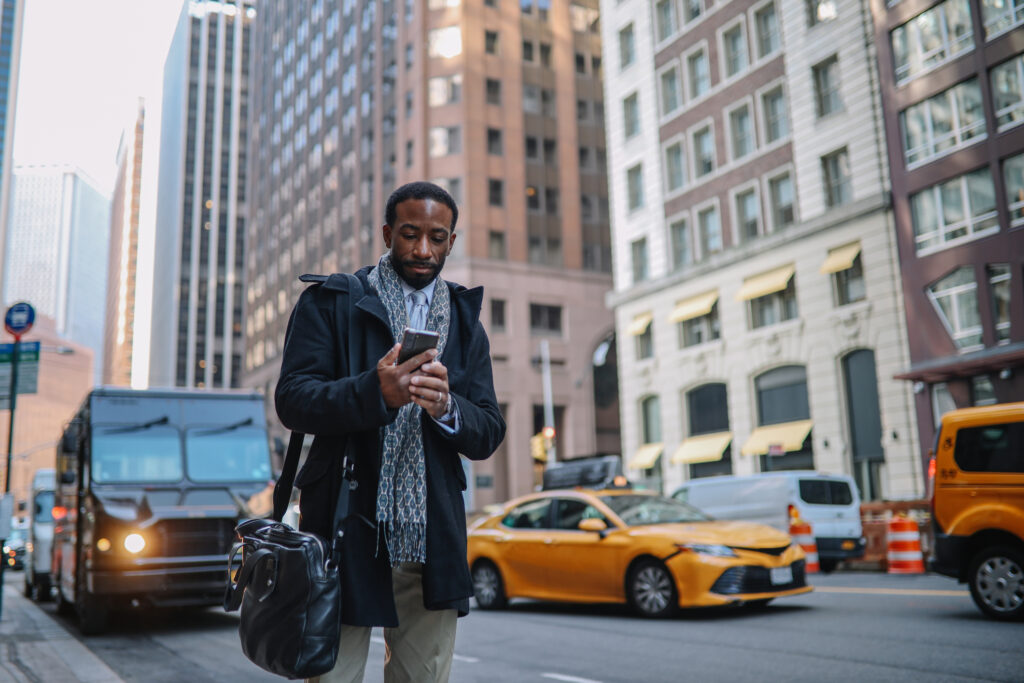 A man waiting for this rideshare in the city.