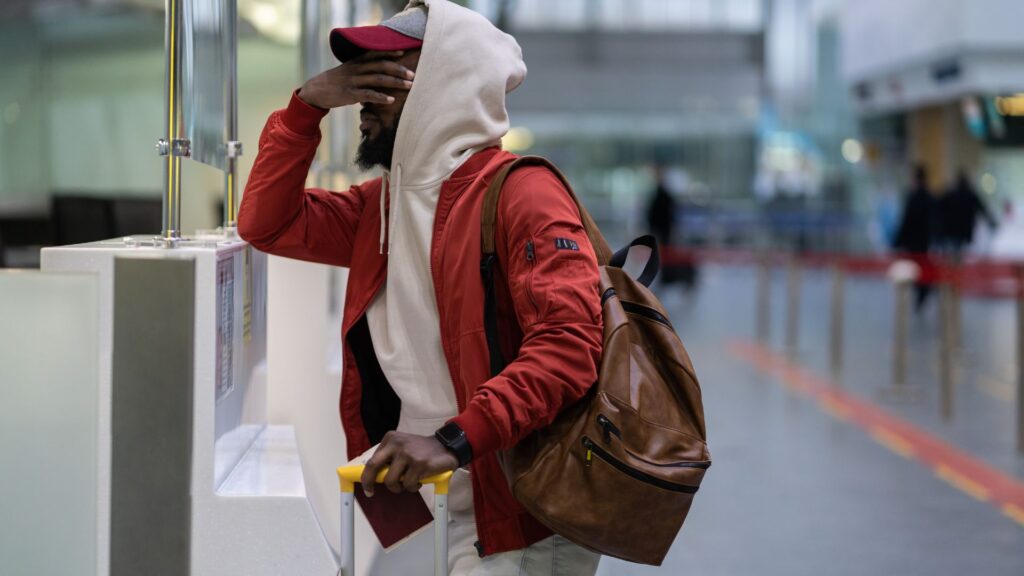 A man stressing out because he missed his flight.