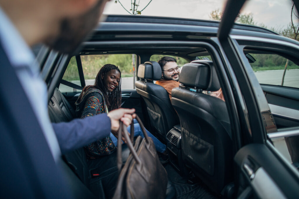 A man getting in an Uber Carpool.