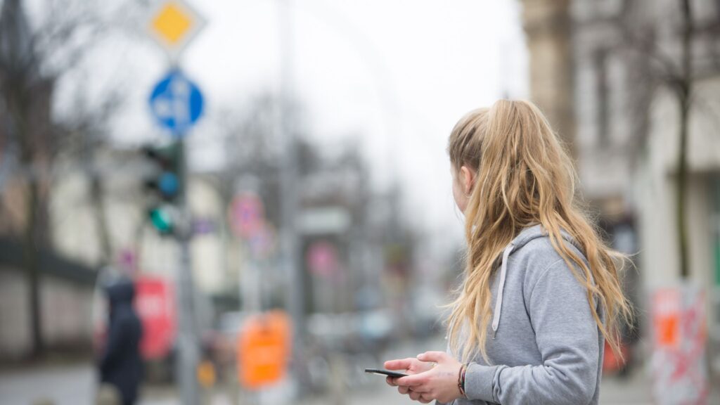 A woman on her phone, looking something up.