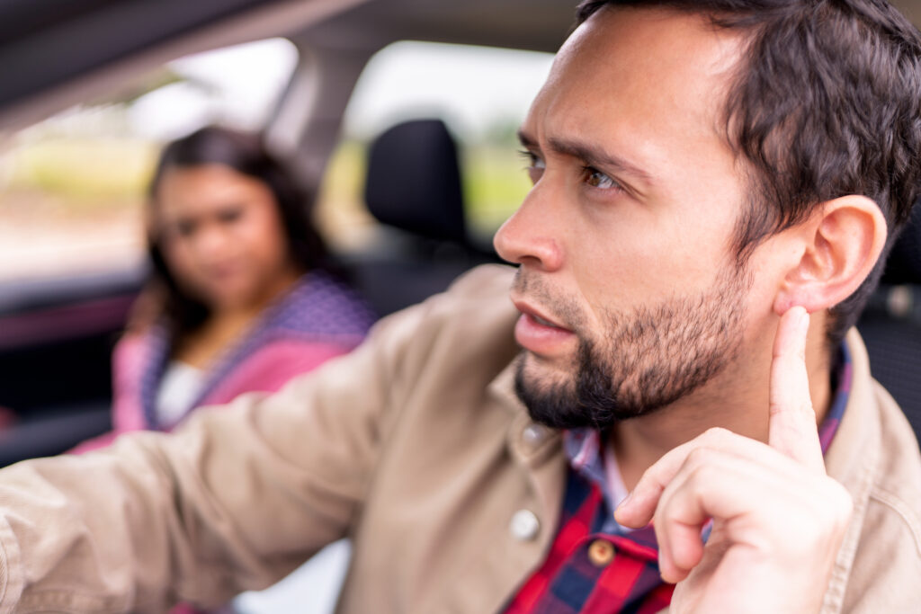 A woman making the car driver angry.